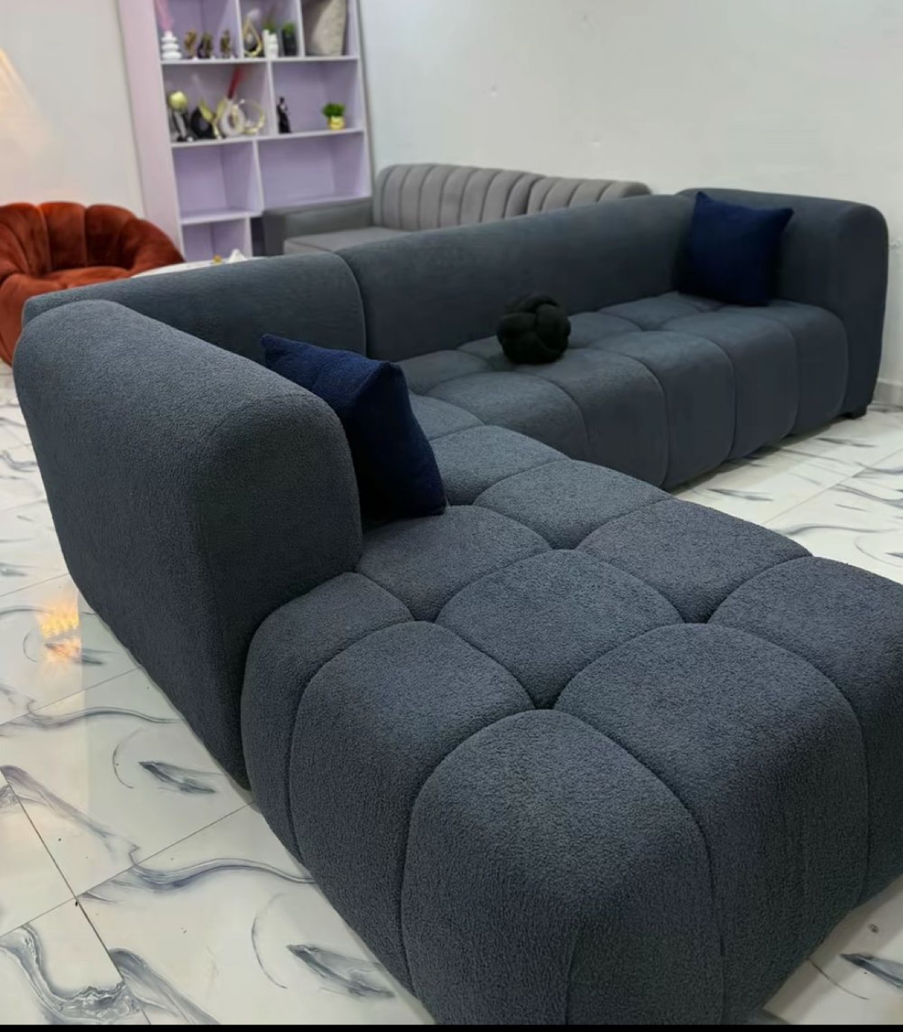 A bouclé sectional suite handmade by Joe's Tech Company in a finished Kumasi home